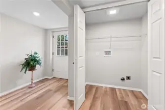 2nd Entrance to Lower Level w/Laminate Floors, Laundry Closet w/Wire Shelving Installed.