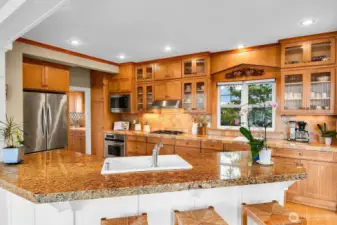 This amazing kitchen has beautiful, custom cabinetry with plenty of room for your dishes, linens and pretty treasures. Note the large counter for guests to gather.