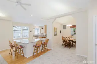 Dining room to the right, extra seating at the kitchen peninsula.
