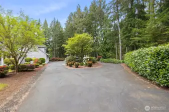 Black top circular drive leads you to the 5 car garage and 2 covered RV/boat parking.