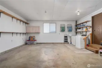Laundry is just outside your kitchen. New washing machine, plenty of storage.