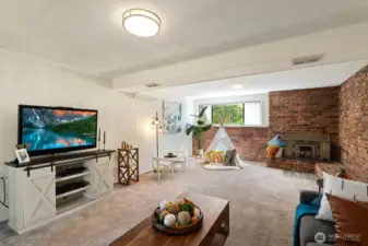 Lower level family room with wood burning fireplace.