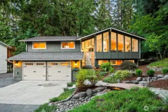 Gorgeous mature landscaping including two water features, stone pathways, and mature plantings.