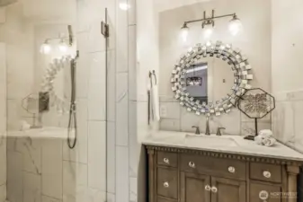 Primary bath includes custom vanity and walk-in shower.