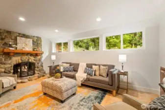 Downstairs family room with stone fireplace and inviting views.