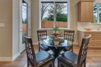 Convenient eating nook located between the kitchen and great room with easy access to the rear landscaped yard.
