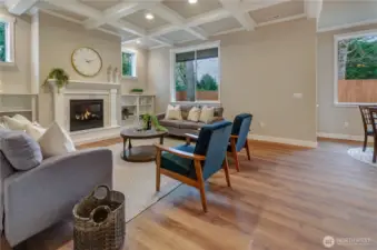 Warn and inviting great room with durable, easy-to-clean hardwood flooring, and large windows providing ample natural light throughout