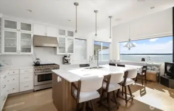 Beautiful waterside kitchen thoughtfully designed for inspired cooking, featuring high-end finishes, smart layout, and sweeping water views.