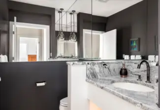 This chic powder room exudes style and sophistication. Thoughtfully designed with high-end finishes, beauty-inspired details, and integrated lighting, it offers a modern, glamorous touch that makes every visit feel luxurious.