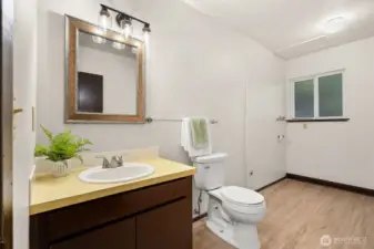 Roomy and convenient lower level laundry and half bath.
