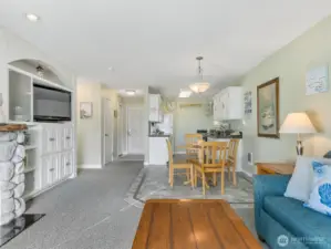 Living room of unit 420 with custom built-in entertainment cabinet with storage.