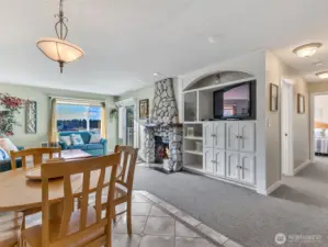 Eat-in dining area and living room of unit 420, and hallway that leads to the bedroom, bathroom, and connects to unit 419.