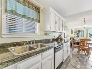 Kitchen with granite-tile countertops. Sink with garbage disposal.