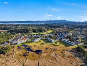 Aerial view of The Breakers. Units 419 and 420 are located in building "D" on the left. Trails lead to the beach; community features in the center include a gazebo with BBQ area, a beach volleyball court, and a playground.