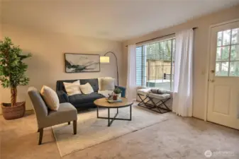 The living room with the door to the back deck.