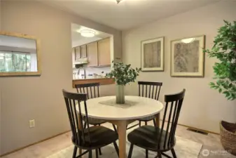 The dining room is spacious with a window to the kitchen.