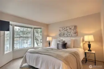 The primary bedroom is spacious with a bay window to the east.