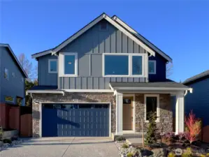 Exterior | Homesite 2  The Robinson plan on the south-facing homesite 2 showcases clean Pacific Northwest contemporary lines with a balanced mix of vertical siding and stone accents. Large upper-level windows introduce natural light while the covered entry creates a defined and welcoming approach. The streamlined façade reflects the architectural character associated with modern luxury new construction.    Located in Bothell’s Canyon Park neighborhood, this thoughtfully designed home is currently under construction. Garage and front door colors are subject to change as finishes are finalized. The residence reflects the quality and craftsmanship expected in new construction homes served by the Northshore School District.    All photos, renderings, site maps, and floorplans are for visualization purposes only.