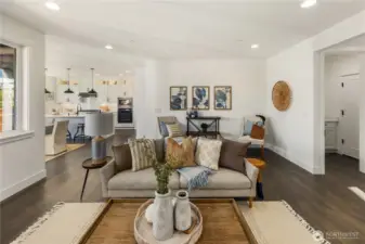 Living Room  The living room centers the main level with a seamless layout designed for flow and connection. Wide plank flooring extends throughout, while recessed lighting and expansive sightlines create an open, cohesive feel between the great room and kitchen beyond. A modern fireplace with textured surround anchors the space, adding warmth and architectural contrast against clean white walls.    Positioned within Bothell near Canyon Park amenities and commuter routes, this integrated living area reflects the craftsmanship associated with high-end contemporary homes. The connected design supports both relaxed daily living and effortless entertaining, a hallmark of thoughtfully built new construction served by the Northshore School District.    These photos are from a past Robinson Plan at a different community, so overall plan, colors, building orientation, finishes, home outlook, and other details can and WILL vary. All photos, renderings, site maps, and floorplans are for visualiz