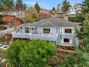 Nestled into the hillside, this Three Tree Point home is an aerial refuge among the trees.