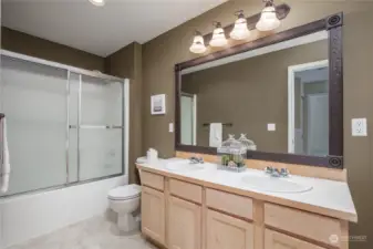 Full upstairs bathroom has dual sinks