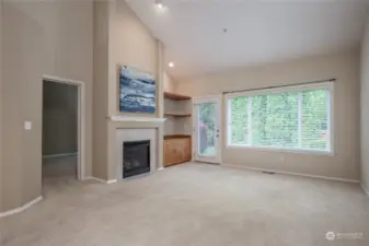 Spacious living room has vaulted ceiling