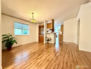 View of the dining area and kitchen and utility/laundry room; also leading to the primary ensuite.