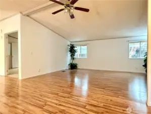 View of the living room and (to the left is) the primary bedroom with ensuite.