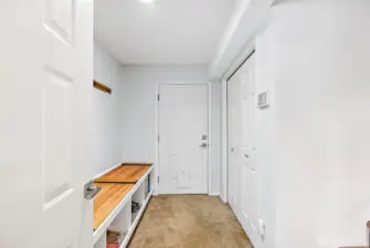 coat closet/shoe bench leading to the garage