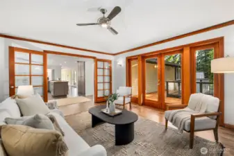 Family room features skylights and an elegant fireplace and open effortlessly onto outdoor deck for al fresco living