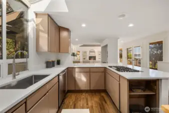 Elegantly refreshed, this chef’s kitchen showcases gleaming quartz countertops, premium stainless steel appliances, and a corner island with seating for up to eight—designed for both lavish entertaining and everyday living.