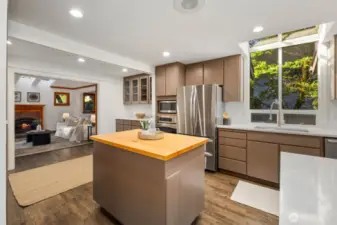 Elegantly refreshed, this chef’s kitchen showcases gleaming quartz countertops, premium stainless steel appliances, and a corner island with seating for up to eight—designed for both lavish entertaining and everyday living.