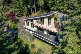 The home has multiple amenities including a detached two car garage, chicken coop, tree house, and other outbuildings.