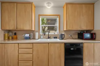 Bright kitchen featuring functional layout, durable laminate flooring, and fresh paint.