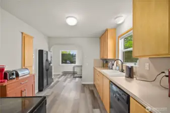 Bright kitchen featuring functional layout, durable laminate flooring, and fresh paint.