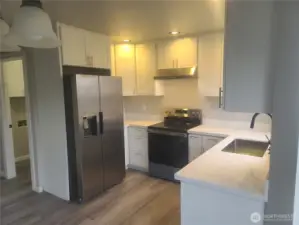 Kitchen view looking into hall to the utility room