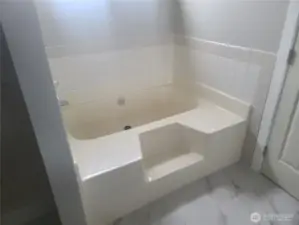 Large soaking tub in the Primary bedroom  bath with separate shower to the left