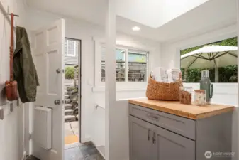 Tiled mudroom offers storage, new windows and access to basement, back yard and kitchen.