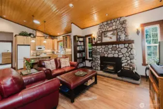 Living room with wood stove insert & river rock fireplace