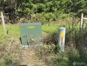 Underground power box and phone on SE corner of property.