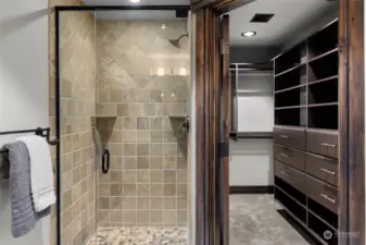 Tiled shower w/pebbled floor in upper bathroom.  Also custom closets.