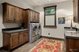 Large mudroom/utility room with great storage.