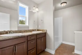 The ensuite bath has two sinks and a large shower!