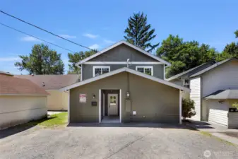 Back of home where main entrance and parking is located on the alley way off Potter Street. 2 large storage units for home, located on both sides of the entry.