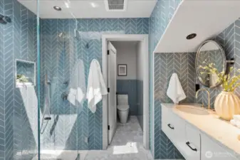 Upper level hall bathroom features skylights