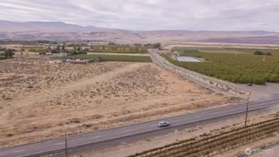 Aerial view of the 243 Highway and the SE corner of the property and water canal.