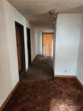 Entry way, Bedroom and bathroom access on Left along with Laundry rm access, Dining rm straignt ahead, Kitchen to Right of Sliding glass door and Living rm access on Right