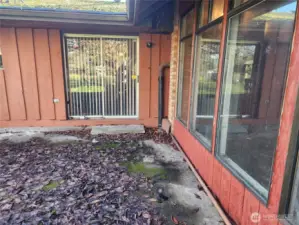 Sliding glass door off of informal dining area. Concrete patio. Large windows allow for plenty of nature light inside attached 2 car garage.