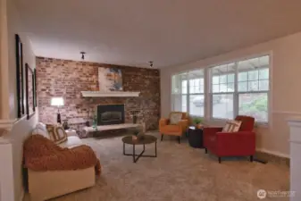 As you enter, the light, bright, but cozy main floor living room welcomes you with its propane fireplace and newer windows.