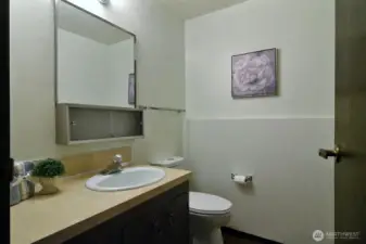 This half bath with new toilet is located on the lower level.